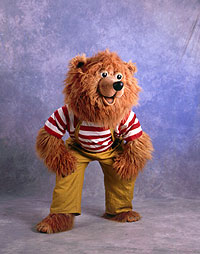 Puppenbau-Bass Bee haut sich auf die Schenkel und lacht